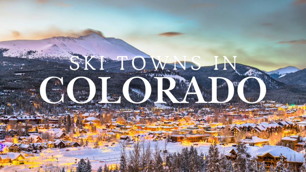 Sunset over a charming Colorado Ski Town, with slopes glowing in the background and buildings lit up, showcasing the beauty of winter in Colorado Ski Towns
