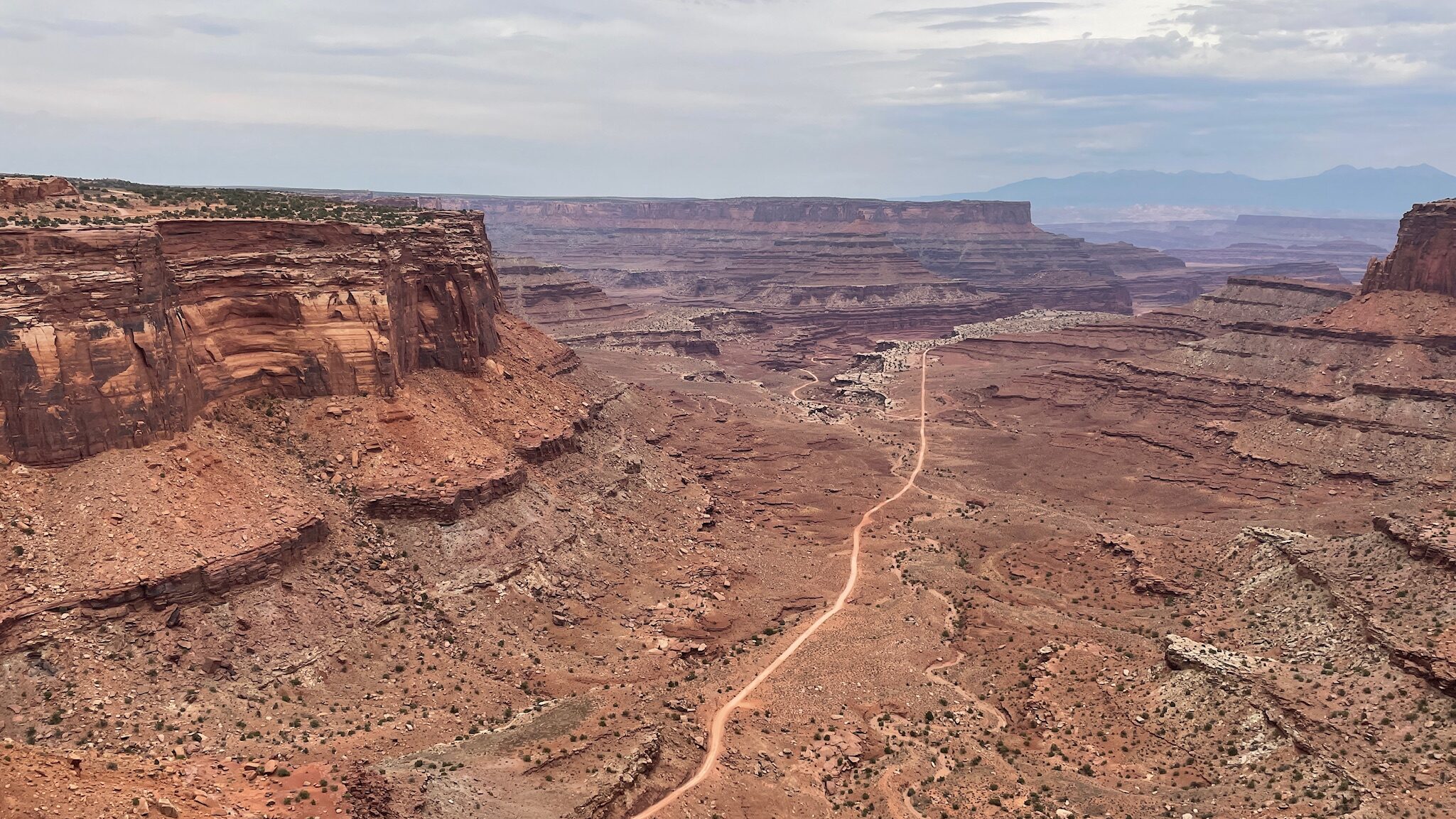 Discover the best national parks to visit in December with this stunning view of Canyonlands National Park, showcasing its vast, rugged landscape and unique rock formations.