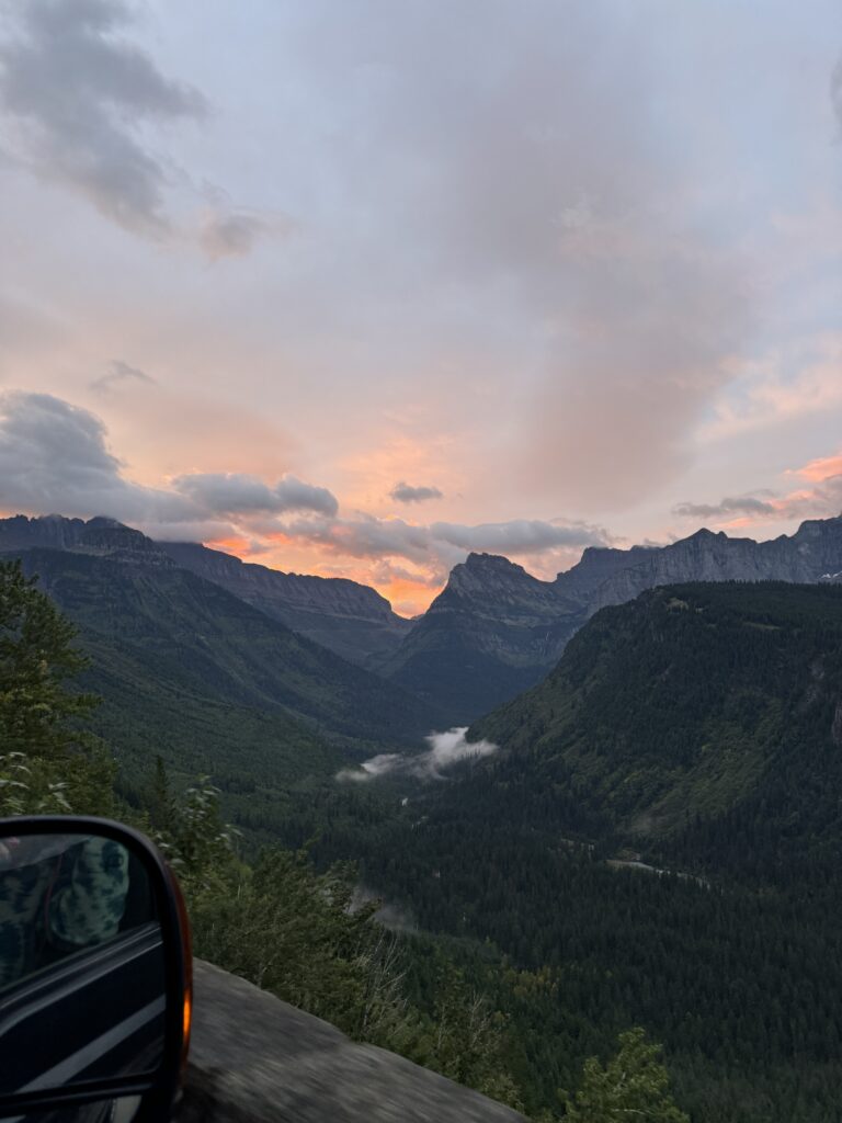 Driving Going-to-the-Sun Road at sunrise, showcasing stunning alpine views on one of the most iconic national park scenic drives.