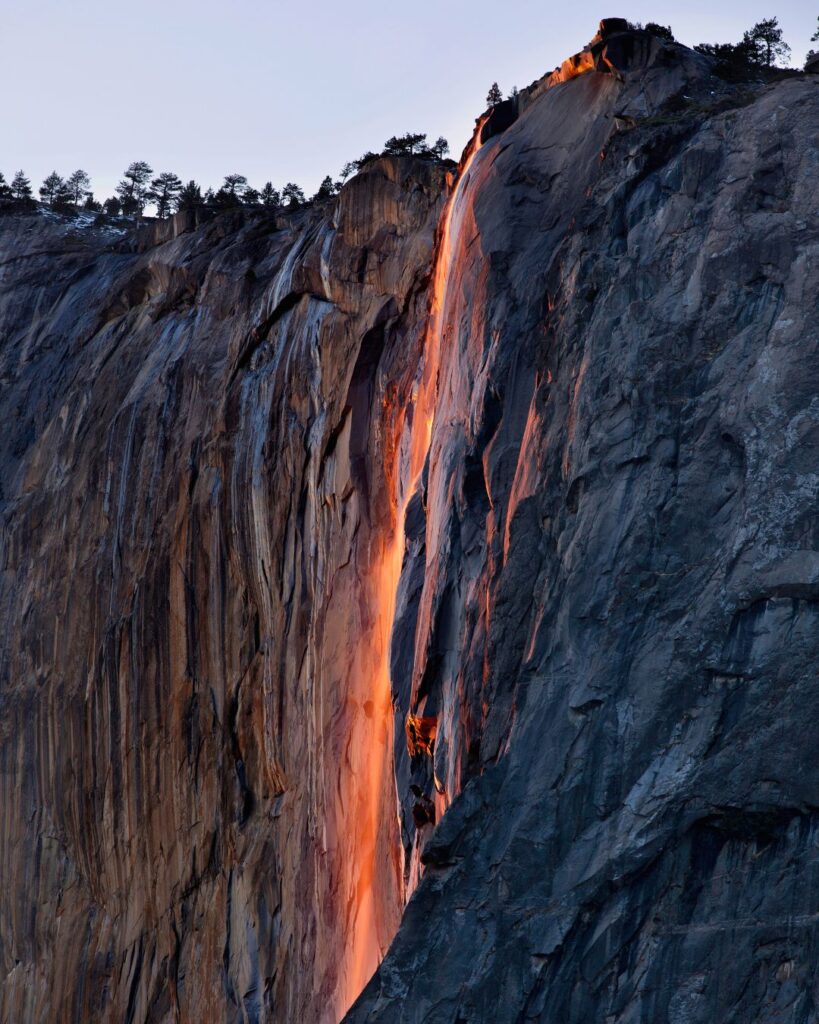 Yosemite Falls at Yosemite National Park glowing during the firefall event, one of the top waterfalls in US National Parks.