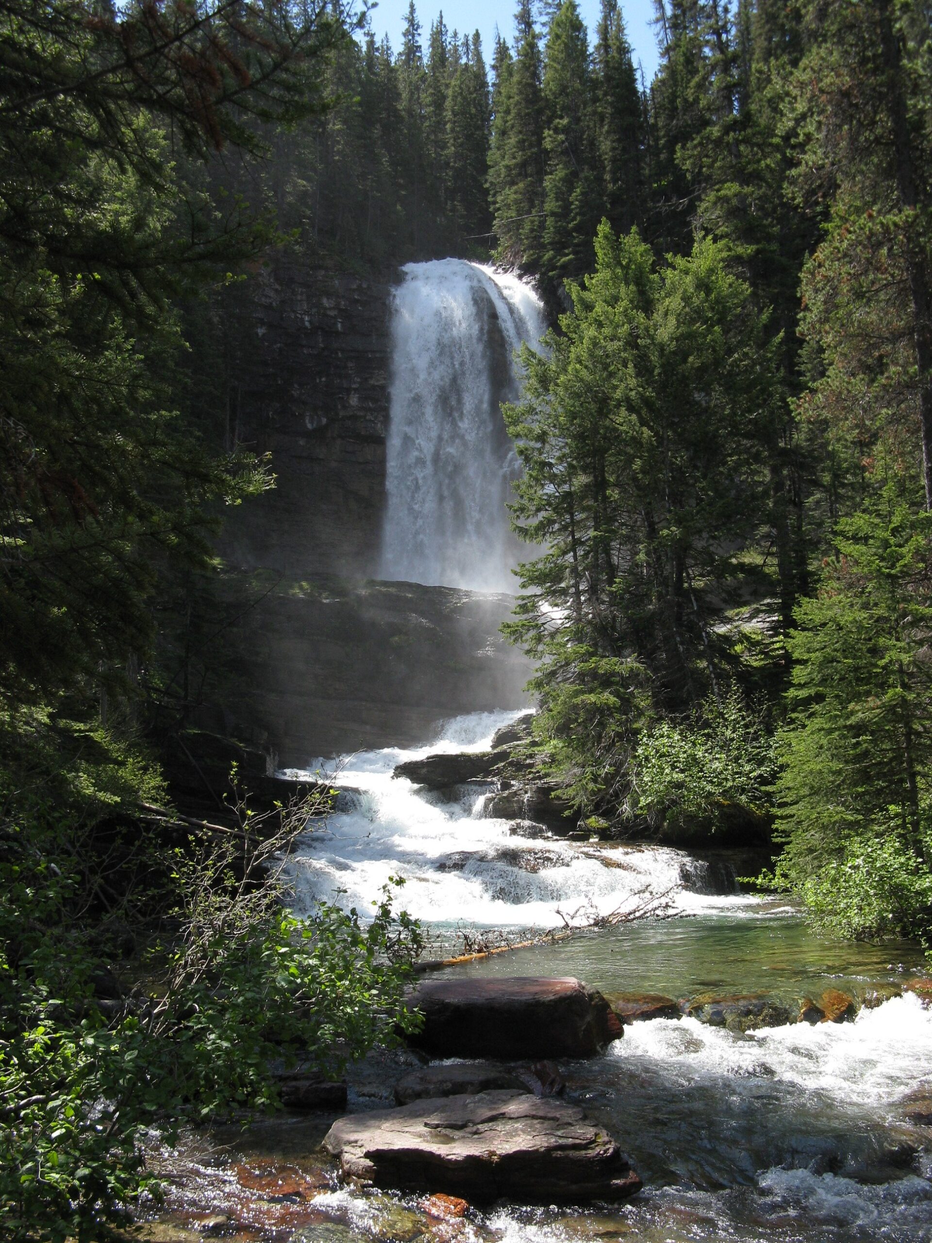 Virginia Falls at Glacier National Park surrounded by vibrant foliage, a must-see among the top waterfalls in US National Parks.