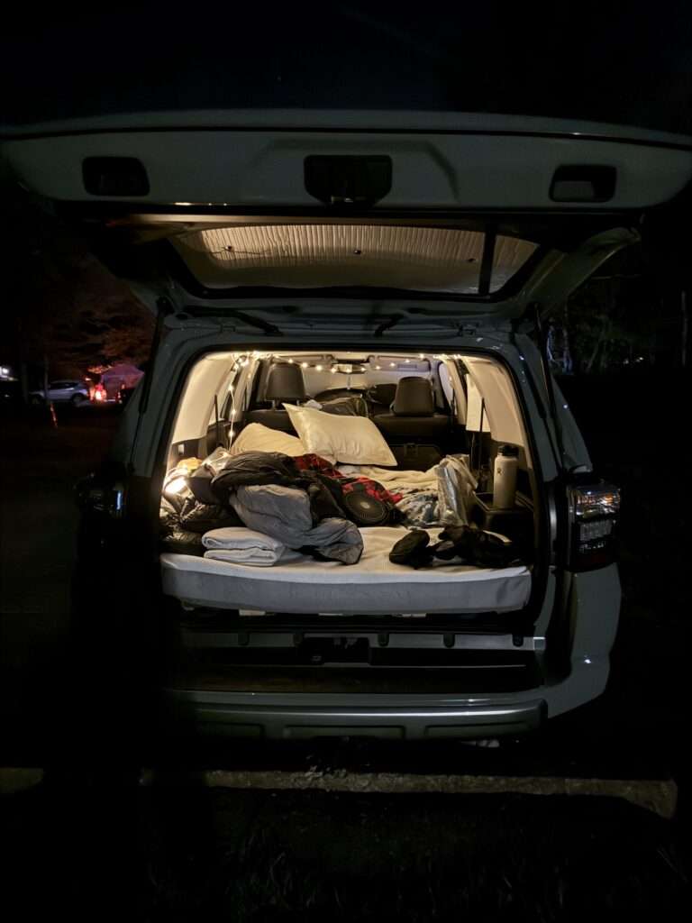 An inside look of our car camping setup at night.
