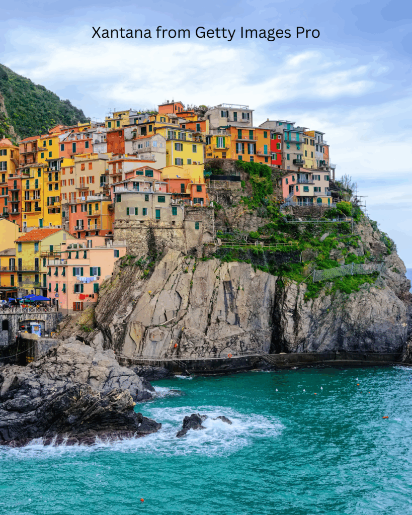 Colorful houses hanging on a rock in the picturesque Manarola Old Town on Mediterranean sea coast, Cinque Terre, Liguria, Italy. 